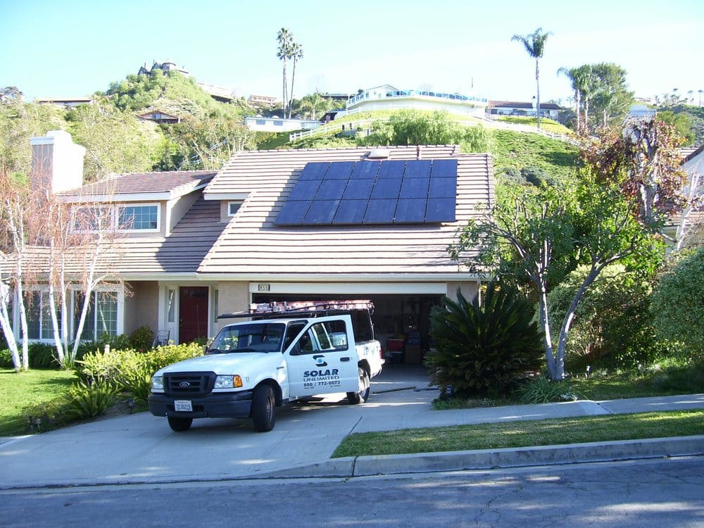 Solar Unlimited truck in front of house with Solar Panels